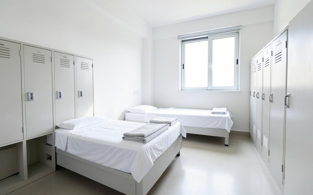 Fullerton Navigation Center — Illumination — Sleeping area with beds and lockers